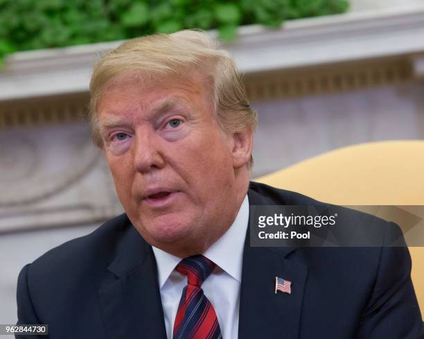 President Donald Trump listens during a meeting with Joshua Holt, members of Holt's family and the congressional delegation of Utah at The White...