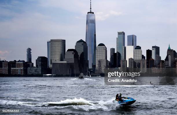 People ride jet ski on Hudson River on a hot day in New York, United States on May 26, 2018.