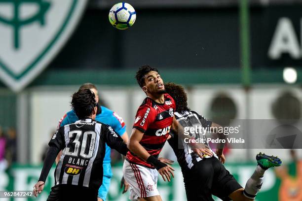 Gustavo Blanco and Luan of Atletico MG and Duarte of Flamengo battle for the ball during a match between Atletico MG and Flamengo as part of...