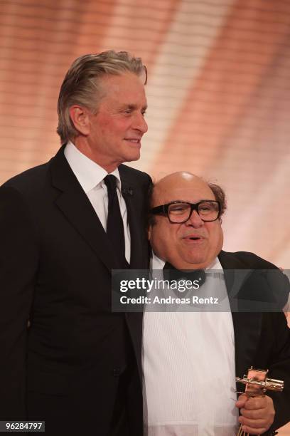 Michael Douglas hands over the award to Danny Devito for 'Lifetimeachievement International' during the Goldene Kamera 2010 Award at the Axel...