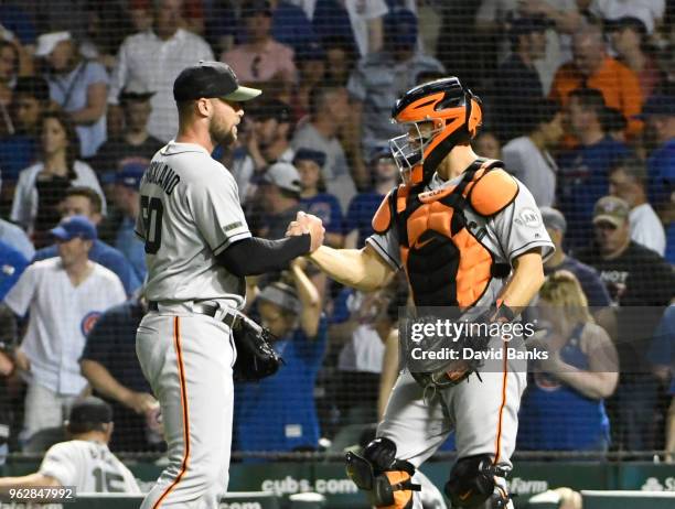 Hunter Strickland of the San Francisco Giants and Nick Hundley celebrate their win on May 26, 2018 at Wrigley Field in Chicago, Illinois. The Giants...