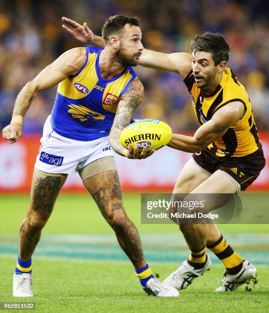 Chris Masten of the Eagles handballs from Ricky Henderson of the Hawks during the round 10 AFL match between the Hawthorn Hawks and the West Coast...