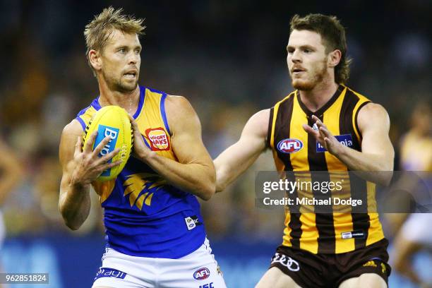 Mark LeCras of the Eagles marks the ball against Blake Hardwick of the Hawks during the round 10 AFL match between the Hawthorn Hawks and the West...