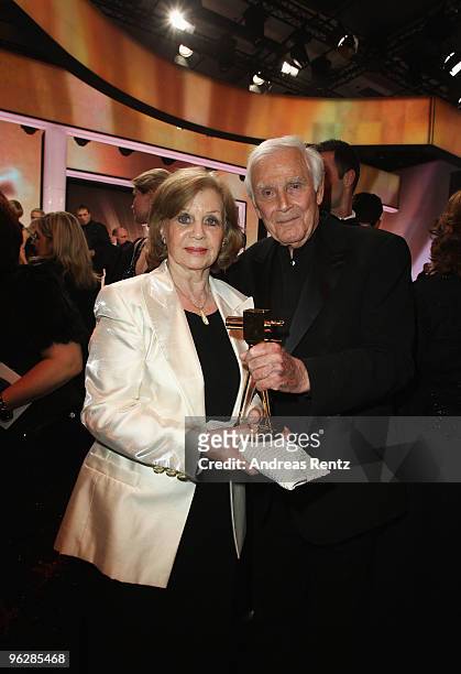 Joachim Fuchsberger and his wife Gundel pose with the award for 'Lifetime Achievement National' during the Goldene Kamera 2010 Award at the Axel...