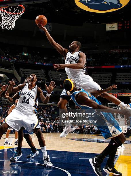 Sam Young of the Memphis Grizzlies shoots over Julian Wright of the New Orleans Hornets on January 30, 2010 at FedExForum in Memphis, Tennessee. NOTE...