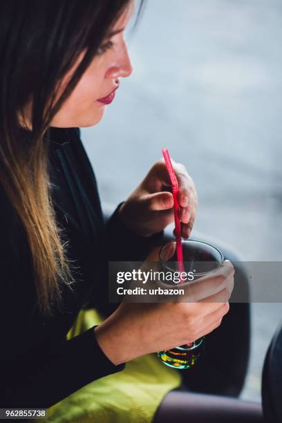 woman relaxing in cafe and drinking juice. - straw lips stock pictures, royalty-free photos & images