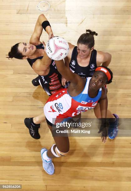 Sam Wallace of the Swifts is challenged by Sharni Layton and Matilda Garrett of the Magpies during the round five Super Netball match between the...