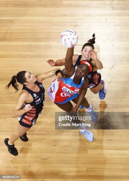 Sam Wallace of the Swifts is challenged by Sharni Layton and Matilda Garrett of the Magpies during the round five Super Netball match between the...