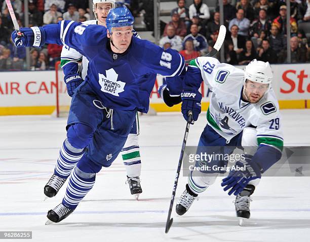 Wayne Primeau of the Toronto Maple Leafs skates with Aaron Rome of the Vancouver Canucks during game action January 30, 2010 at the Air Canada Centre...