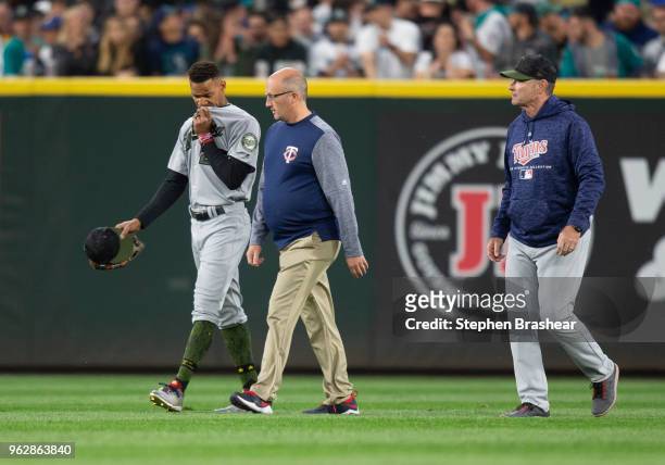 Centerfielder Byron Buxton of the Minnesota Twins leaves the game with manager Paul Molitor and Minnesota Twins training staff after slamming into...