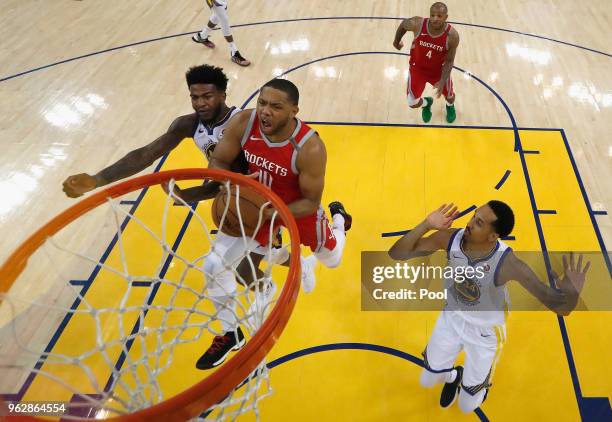 Eric Gordon of the Houston Rockets goes up for a shot against Jordan Bell and Shaun Livingston of the Golden State Warriors during Game 6 of the...