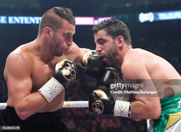 David Lemieux of Canada punches Karim Achour of France during their middleweight fight at the Videotron Center on May 26, 2018 in Quebec City,...