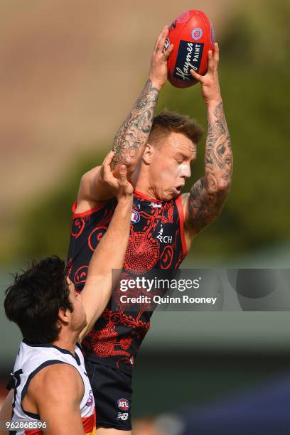 James Harmes of the Demons marks over the top of Darcy Fogarty of the Crows during the round 10 AFL match between the Melbourne Demons and the...