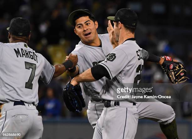 Manuel Margot , Christian Villanueva and Matt Szczur of the San Diego Padres celebrate after defeating the Los Angeles Dodgers at Dodger Stadium on...