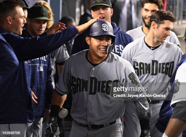 Christian Villanueva of the San Diego Padres is greeted in the dugout after his second home run of the game in the eighth inning against the Los...