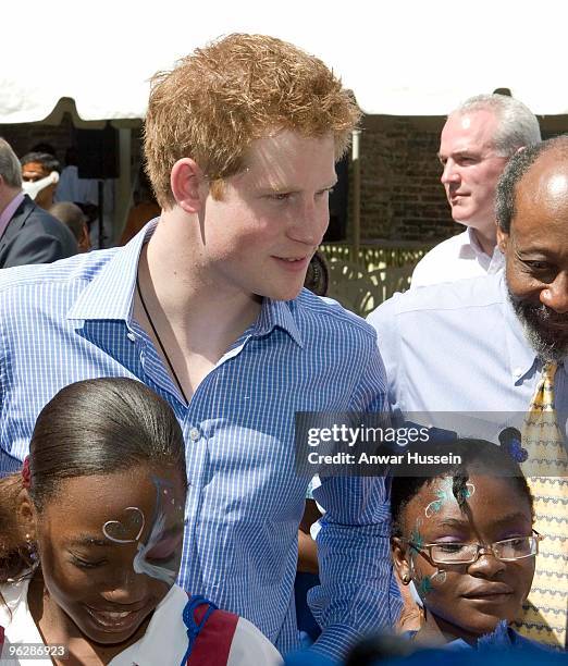 Prince Harry meets children at a garden party for orphans aand vulnerable children at the Garrison Museum on January 30, 2010 in Bridgetown,...