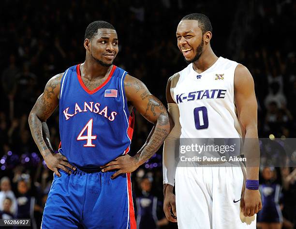 Guard Sherron Collins of the Kansas Jayhawks shares a laugh with guard Jacob Pullen of the Kansas State Wildcats in the second half on January 30,...