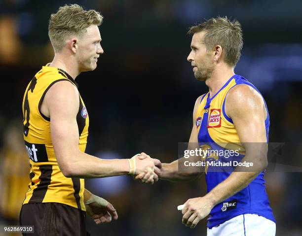 Defeated James Sicily of the Hawks and Mark LeCras of the Eagles shake hands after the round 10 AFL match between the Hawthorn Hawks and the West...