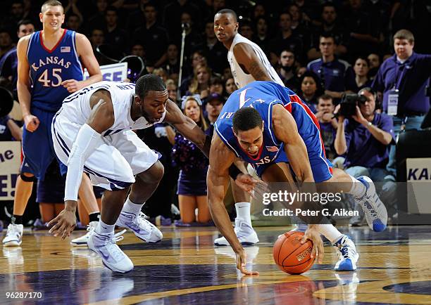 Guard Xavier Henry of the Kansas Jayhawks scrambles for a loose ball with guard Jacob Pullen of the Kansas State Wildcats in the second half on...