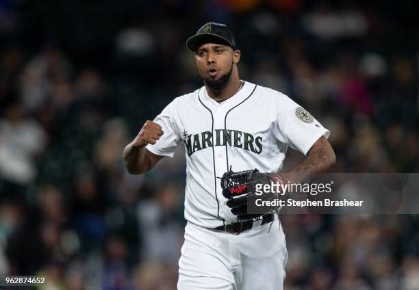 Relief pitcher Juan Nicasio of the Seattle Mariners reacts as he walks off the field during the eleventh inning of a game against the Minnesota Twins...