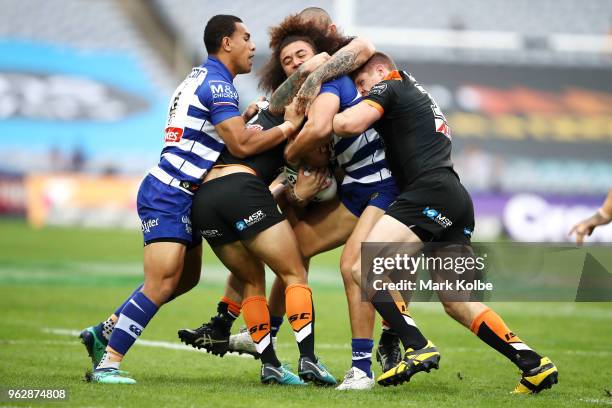 Raymond Faitala-Mariner of the Bulldogs is tackled during the round 12 NRL match between the Wests Tigers and the Canterbury Bulldogs at ANZ Stadium...