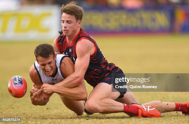 Tom Doedee of the Crows is tackled by Mitch Hannan of the Demons during the round 10 AFL match between the Melbourne Demons and the Adelaide Crows at...