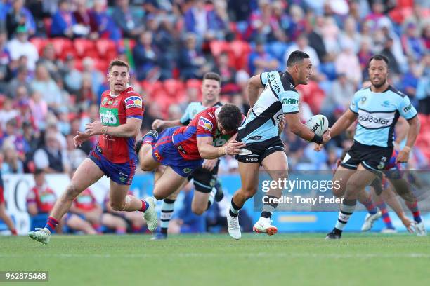 Valentine Holmes of the Sharks is tackled during the round 12 NRL match between the Newcastle Knights and the Cronulla Sharks at McDonald Jones...