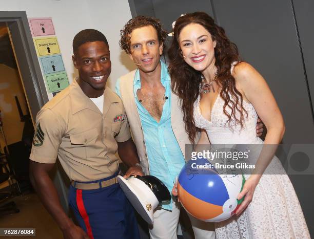 Members of the United States Military pose with Alison Luff and Paul Alexander Nolan of the cast of the Jimmy Buffett Broadway Musical "Escape to...