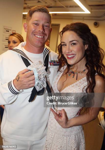 Members of the United States Military pose with Alison Luff of the cast of the Jimmy Buffett Broadway Musical "Escape to Margaritaville" backstage to...