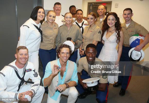 Members of the United States Military pose with Alison Luff and Paul Alexander Nolan of the cast of the Jimmy Buffett Broadway Musical "Escape to...