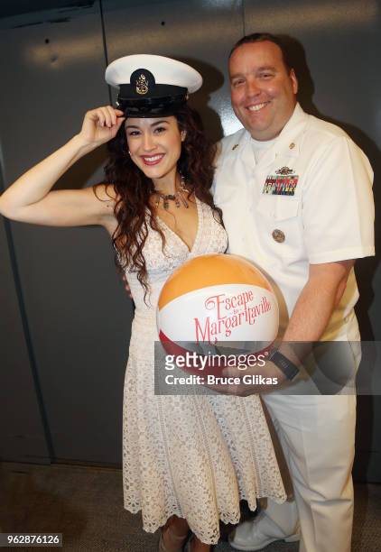 Members of the United States Military pose with Alison Luff of the cast of the Jimmy Buffett Broadway Musical "Escape to Margaritaville" backstage to...