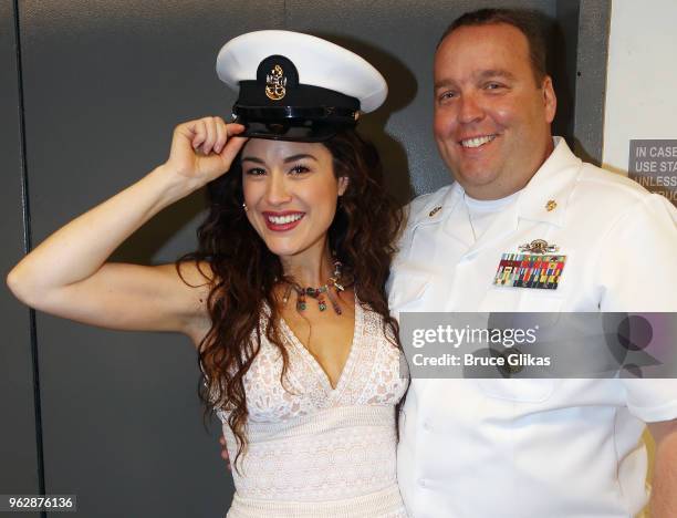 Members of the United States Military pose with Alison Luff of the cast of the Jimmy Buffett Broadway Musical "Escape to Margaritaville" backstage to...