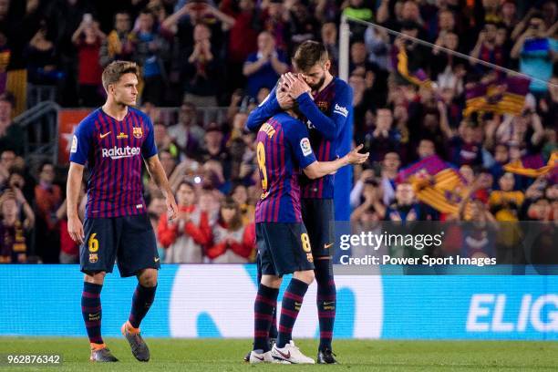Andres Iniesta of FC Barcelona hugs his teammate Gerard Pique Bernabeu before leaving the field during the La Liga match between Barcelona and Real...