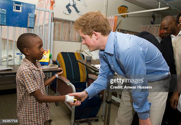 Prince Harry meets a young patient when he visits the childrens ward at the Queen Elizabeth ll hospital on January 30, 2010 in Bridgetown, Barbados....