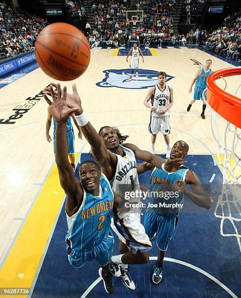 Darren Collison of the New Orleans Hornets and DeMarre Carroll of the Memphis Grizzlies jump for a rebound on January 30, 2010 at FedExForum in...