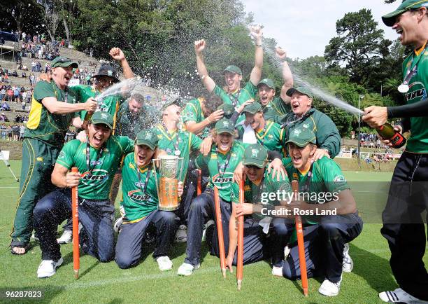 Jacob Oram sprays his Central Stag team mates with Champagne after they won the HRV Twenty20 cricket match over the Auckland Aces at Pukekura Park on...