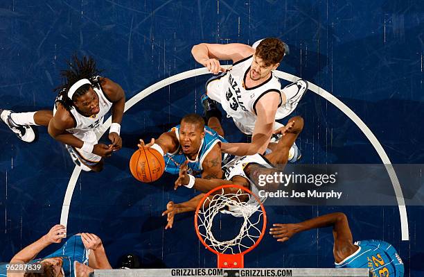 David West of the New Orleans Hornets battles for a rebound against DeMarre Carroll, Marc Gasol, and Hasheem Thabeet of the Memphis Grizzlies on...