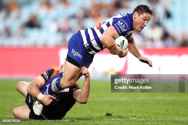 Josh Jackson of the Bulldogs is tackled during the round 12 NRL match between the Wests Tigers and the Canterbury Bulldogs at ANZ Stadium on May 27,...