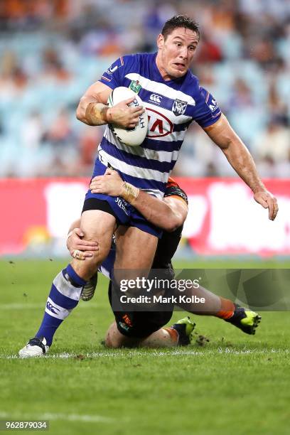 Josh Jackson of the Bulldogs is tackled during the round 12 NRL match between the Wests Tigers and the Canterbury Bulldogs at ANZ Stadium on May 27,...