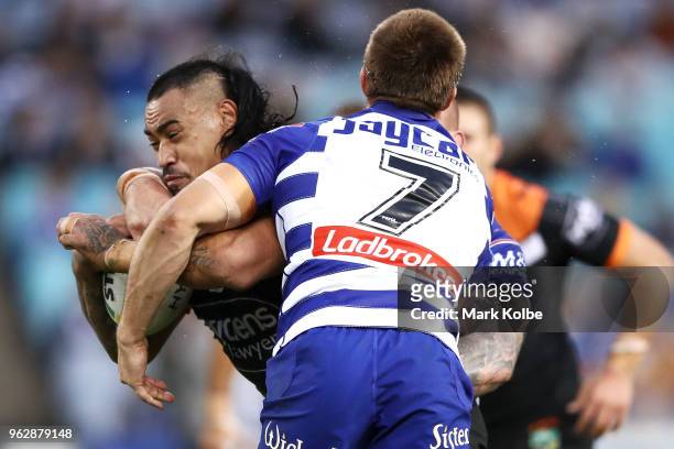 Mahe Fonua of the Tigers is tackled during the round 12 NRL match between the Wests Tigers and the Canterbury Bulldogs at ANZ Stadium on May 27, 2018...