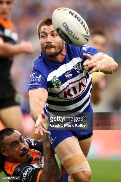 Kieran Foran of the Bulldogs passes as he is tackled during the round 12 NRL match between the Wests Tigers and the Canterbury Bulldogs at ANZ...