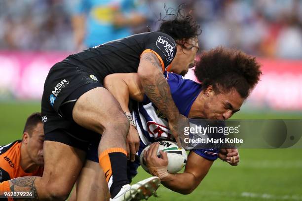 Raymond Faitala-Mariner of the Bulldogs is tackled during the round 12 NRL match between the Wests Tigers and the Canterbury Bulldogs at ANZ Stadium...