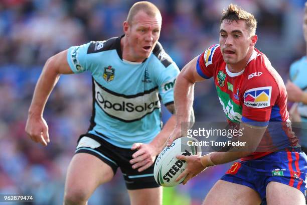 Connor Watson of the Knights passes the ball during the round 12 NRL match between the Newcastle Knights and the Cronulla Sharks at McDonald Jones...