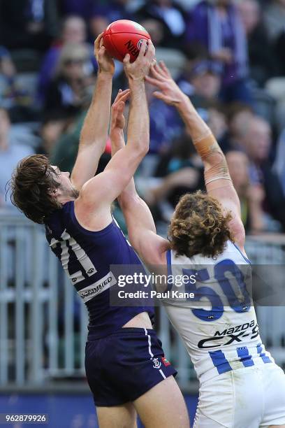 Joel Hamling of the Dockers marks the ball against Ben Brown of the Kangaroos during the round 10 AFL match between the Fremantle Dockers and the...