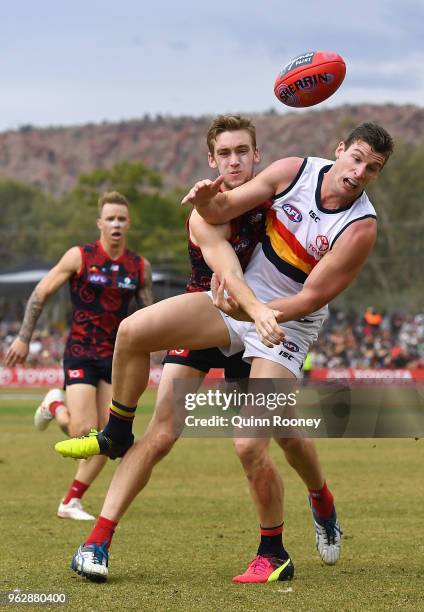 Oscar McDonald of the Demons spoils a mark by Josh Jenkins of the Crows during the round 10 AFL match between the Melbourne Demons and the Adelaide...