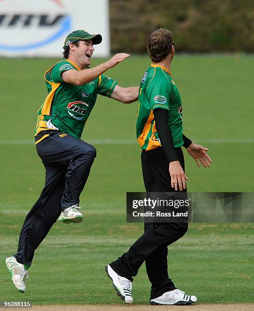 Jacob Oram is congratulated by his captain Jamie Howe after taking the final wicket to win the HRV Twenty20 cricket match over the Auckland Aces at...