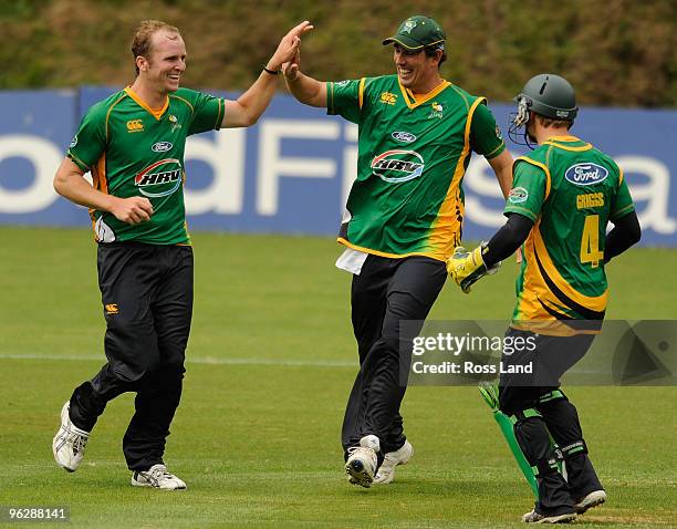 Seth Rance of the Central Staggs is congratulated by Matthew Sinclair and Bevan Griggs after taking a wicket during their win over the Auckland Aces...