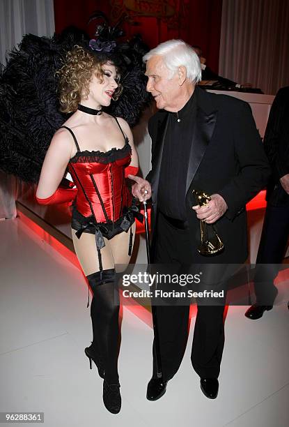 Joachim Fuchsberger jokes with a dancer during the Goldene Kamera 2010 Award at the Axel Springer Verlag on January 30, 2010 in Berlin, Germany.