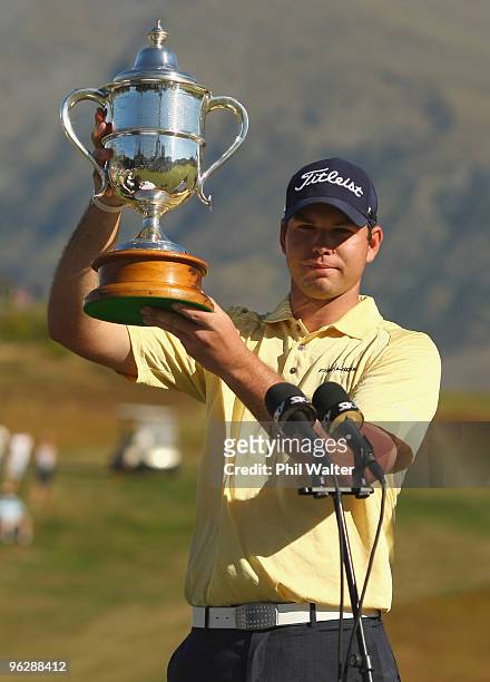 Robert Gates of the USA holds up the trophy following day four of the New Zealand Open at The Hills Golf Club on January 31, 2010 in Queenstown, New...