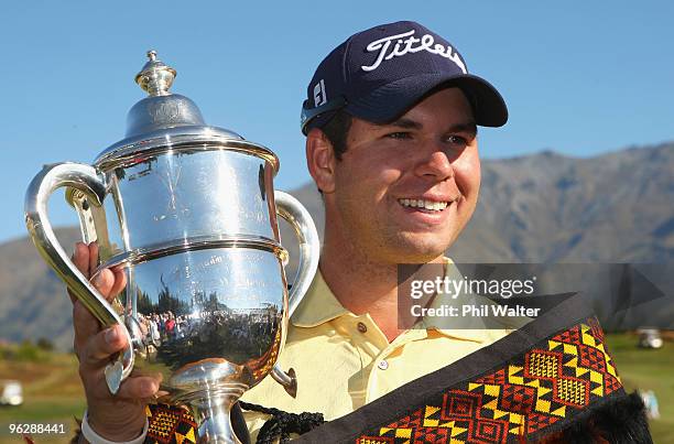 Robert Gates of the USA poses with the winners trophy following day four of the New Zealand Open at The Hills Golf Club on January 31, 2010 in...